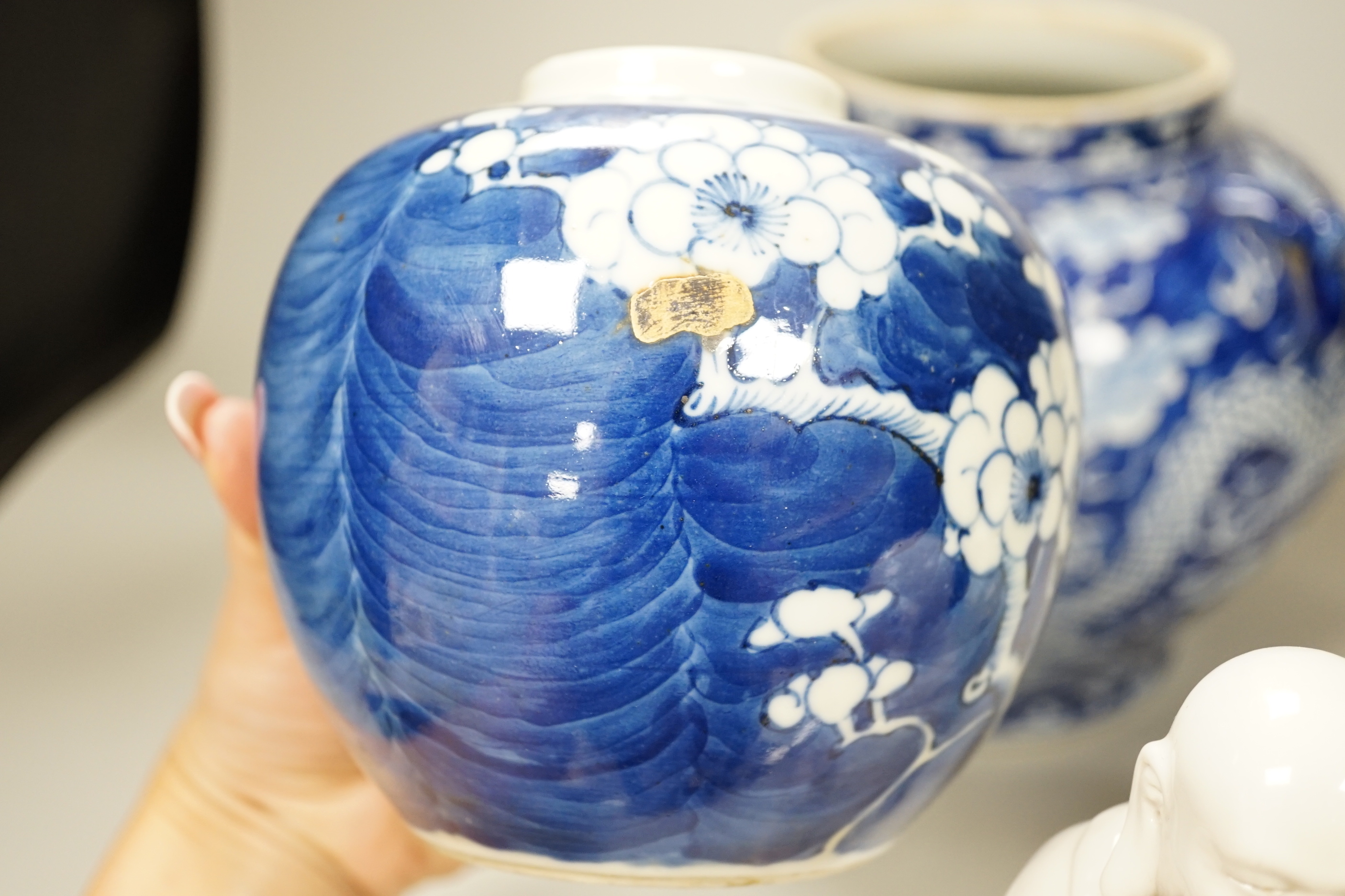 A group of Chinese ceramics including a celadon glazed vase, blue and white jar, white glazed figure and a jardiniere